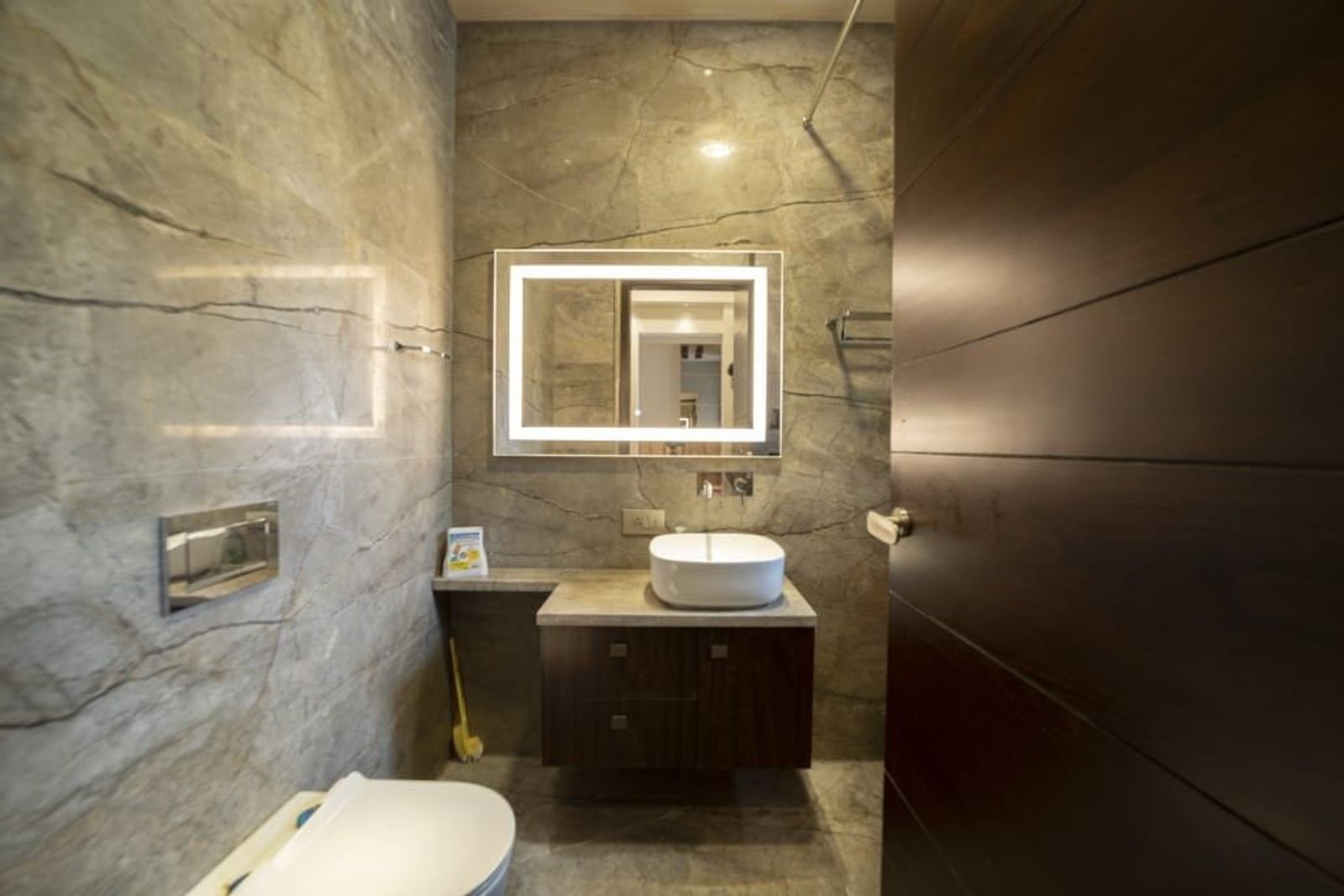 Stone to the ceiling, timber below the basin